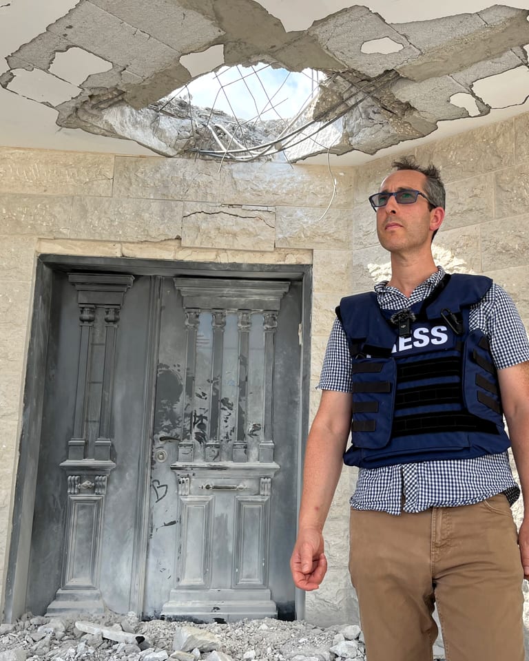 Nathan Jeffay reporting on location in Israel, wearing a press vest
